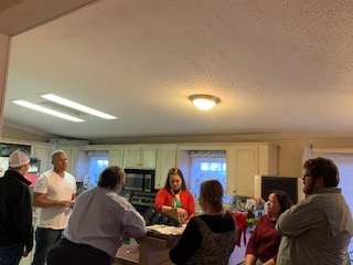 Some adults talking at the Christmas Cookie Party