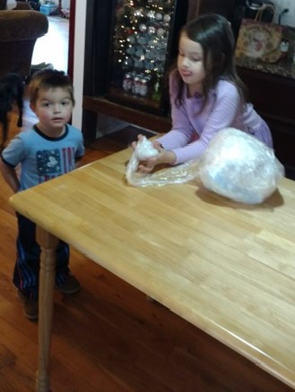 Little ones helping wrap Saran Wrap Balls!